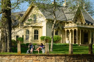 Two students sitting and chatting on the bench in front of Finn House