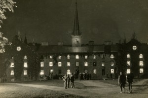 Archival photo of Old Kenyon lit with candles