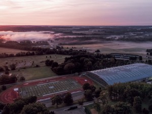 An overhead shot of the Lowry Center and the football field at dawn