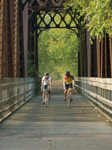 Two students cycling across the trestle on the Kokosing Gap Trail