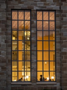 A detail of the Carver Reading Room windows in Chalmers Library lit up at night