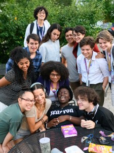 A group photo of KEEP students sitting and standing around an outdoor table in the center of Gambier