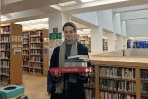 A photo of tutor Celeste holding some books