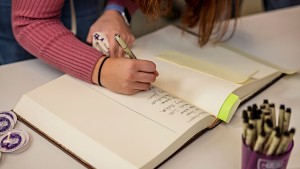 Student signing the Matriculation Book